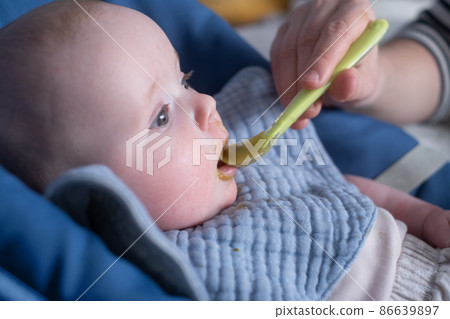 Feeding a little caucasian baby for first time. Feeding a little caucasian baby for first time. 86639897