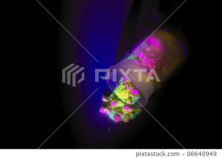 Fluorescent organic materials of red, yellow and green color for production OLED inside glass bottle in UV light. 86640949