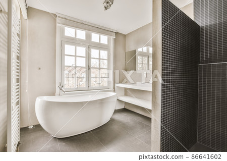 Stunning bathroom design with black shower cabin and modern bathtub Stunning bathroom design with black shower cabin and modern bathtub 86641602
