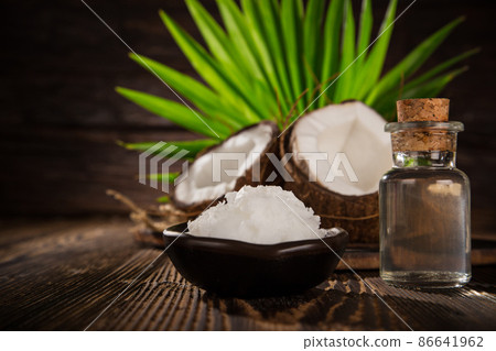 Coconut pieces isolated on wooden background 86641962