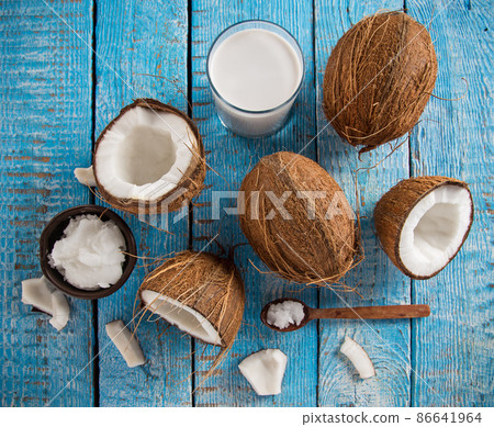 Coconut pieces on wooden background 86641964