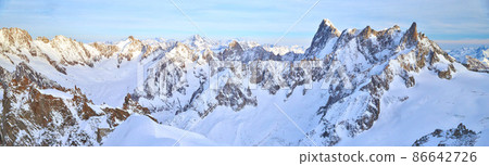 The mountain Aiguille du Midi 3842 meters in the Mont Blanc massif in the French Alps at sunset, panoramic image, peaks of mountains The mountain Aiguille du Midi 3842 meters in the Mont Blanc massif in the French Alps at sunset, panoramic image, peaks of mountains 86642726