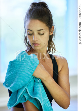 I got a good glow session today. Shot of a woman drying herself with a towel after her workout. 86643580