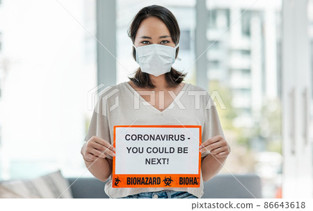No one is exempt. Shot of a woman holding up a sign saying CORONAVIRUS - YOU COULD BE NEXT. No one is exempt. Shot of a woman holding up a sign saying CORONAVIRUS - YOU COULD BE NEXT. 86643618