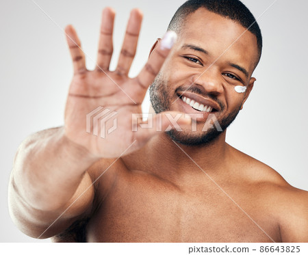Keep your skin in tip-top shape with a hydrated moisturiser. Studio portrait of a handsome young man with moisturiser on his face and finger against a white background. Keep your skin in tip-top shape with a hydrated moisturiser. Studio portrait of a handsome young man with moisturiser on his face and finger against a white background. 86643825