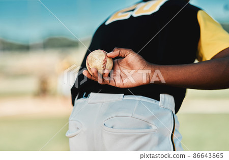 He plays his position well. Rearview shot of a baseball player holding the ball behind his back. 86643865