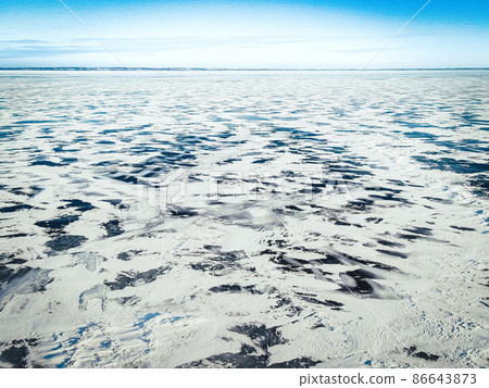 Elevated view over the frozen icy lake with blue sky 86643873
