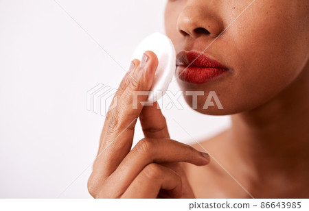 A cotton pad is gentle on your skin. Studio shot of an unrecognizable woman using a cotton pad to remove her lipstick. A cotton pad is gentle on your skin. Studio shot of an unrecognizable woman using a cotton pad to remove her lipstick. 86643985