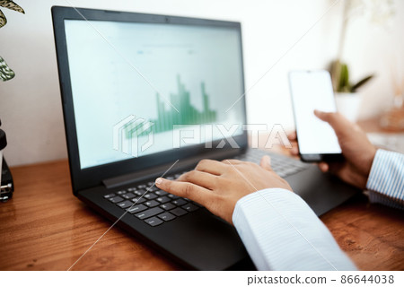 Time to balance the virtual books. Cropped shot of a businesswoman using a laptop and smartphone while analysing financial data at her desk. 86644038