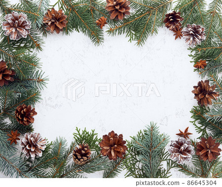 Christmas and Happy New Year light white background. Frame with fir branches, cones Christmas and Happy New Year light white background. Frame with fir branches, cones 86645304