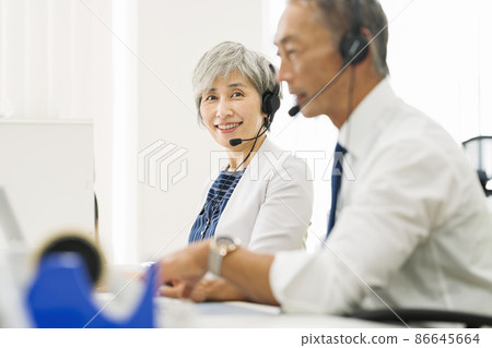 Employees in their 50s working at a call center 86645664