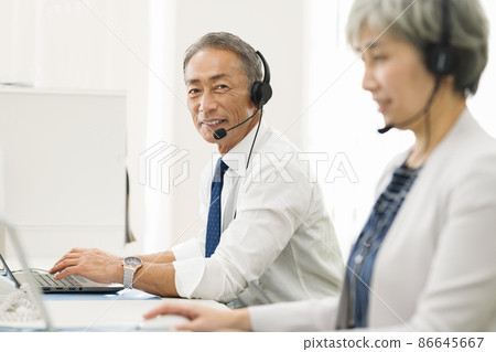 Employees in their 50s working at a call center 86645667