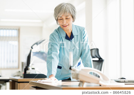Cleaning staff wiping desks in the office 86645826