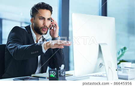 I see the problem Ill have it fixed. Shot of a young businessman working in a call center. I see the problem Ill have it fixed. Shot of a young businessman working in a call center. 86645956