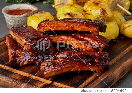 Spicy barbecue pork ribs and crushed smashed potatoes. Slow cooking recipe Spicy barbecue pork ribs and crushed smashed potatoes. Slow cooking recipe 86646034