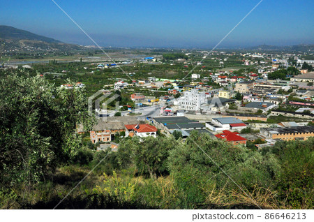 A bird's-eye view of the city at the foot of the slope from the slope to the Berat fort in Albania A bird's-eye view of the city at the foot of the slope from the slope to the Berat fort in Albania 86646213