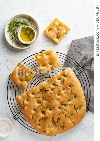 Focaccia, pizza, italian flat bread with rosemary and olive oil on grid 86646397
