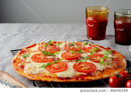 Rustic Italian homemade Pizza Dough margherita topped with pizza sauce 86646399