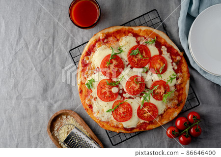 Rustic Italian homemade Pizza Dough margherita topped with pizza sauce n dark backdrop Rustic Italian homemade Pizza Dough margherita topped with pizza sauce n dark backdrop 86646400