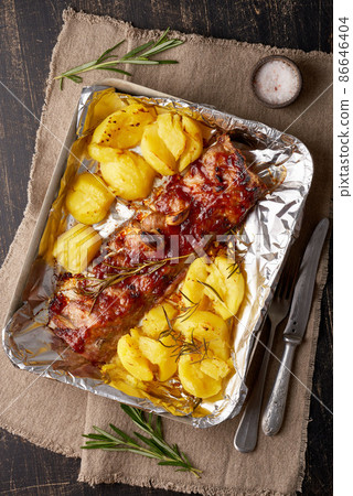 Spicy barbecue pork ribs and crushed smashed potatoes. Slow cooking recipe. 86646404