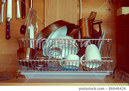 Pure cleaned crockery placed on dryer washed after Breakfast in kitchen 86646426