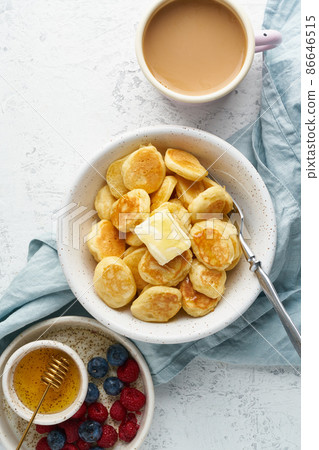 Pancakes cereal, tiny thin funny crumpet, children's food. Breakfast with drink 86646515