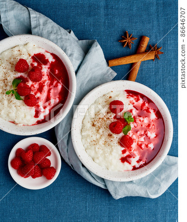 Two rice pudding. French milk rice dessert with raspberries, blueberries. Top view, vertical 86646707