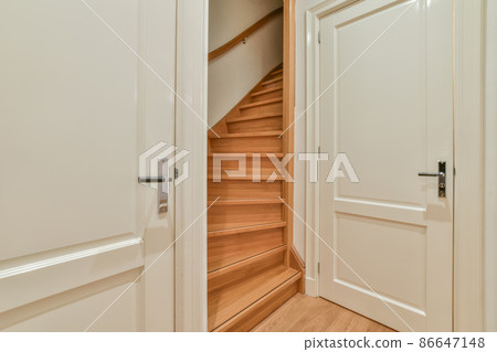 a wooden staircase in a hallway with wooden floor 86647148