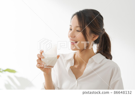 Female drinking milk white background 86648132