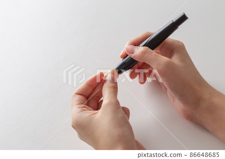 Diabetes concept, Human taking blood sample with lancet pen to check blood sugar. Diabetes concept, Human taking blood sample with lancet pen to check blood sugar. 86648685