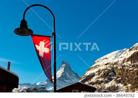 Swiss flag and Matterhorn mountain 86648782