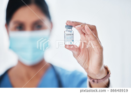 Were armed and ready to fight this virus. Shot of a medical practitioner holding a vial with COVID-19 on it. Were armed and ready to fight this virus. Shot of a medical practitioner holding a vial with COVID-19 on it. 86648919