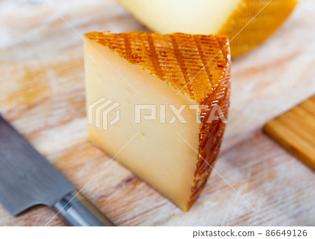 View of a piece of semi-hard cheese View of a piece of semi-hard cheese 86649126