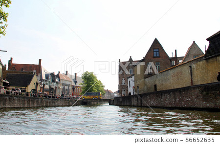 Bruges skyline seen from a canal cruise ship 86652635