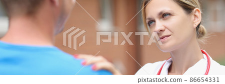 Woman doctor putting hand on patient shoulder to calm down 86654331