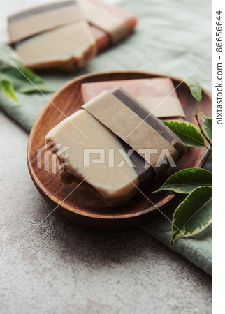 Handmade soap bars and green leaves Handmade soap bars and green leaves 86656644