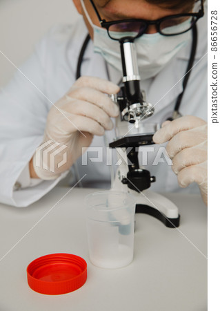 Doctor analyzing semen samples in laboratory. Vertical image 86656728