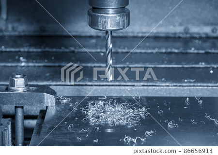 The CNC milling machine drilling process on the metal plate. The CNC milling machine drilling process on the metal plate. 86656913