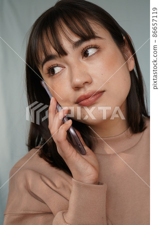 A woman using a smartphone A woman using a smartphone 86657119