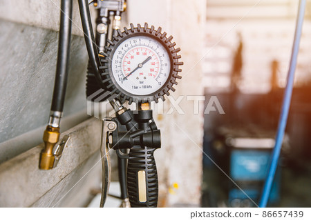 Tire Air pump head with pressure gauge service for car inflation in garage Tire Air pump head with pressure gauge service for car inflation in garage 86657439