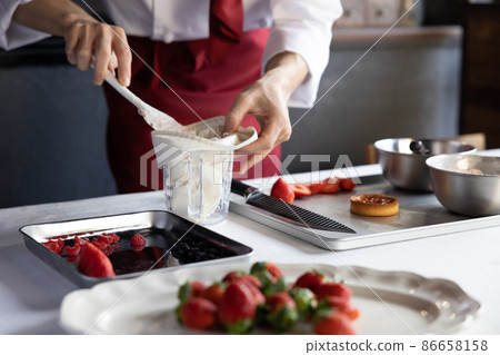 Making sweets at the pastry chef's hand (without face) Making sweets at the pastry chef's hand (without face) 86658158