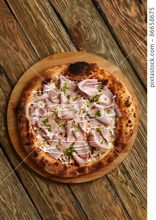 Meat Italian pizza with roast beef, steak slices, melted cheese, with olive slices and cheddar cheese. Close up, macro. Pizza time concept. Meat Italian pizza with roast beef, steak slices, melted cheese, with olive slices and cheddar cheese. Close up, macro. Pizza time concept. 86658675