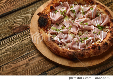 Meat Italian pizza with roast beef, steak slices, melted cheese, with olive slices and cheddar cheese. Close up, macro. Pizza time concept. Meat Italian pizza with roast beef, steak slices, melted cheese, with olive slices and cheddar cheese. Close up, macro. Pizza time concept. 86658680