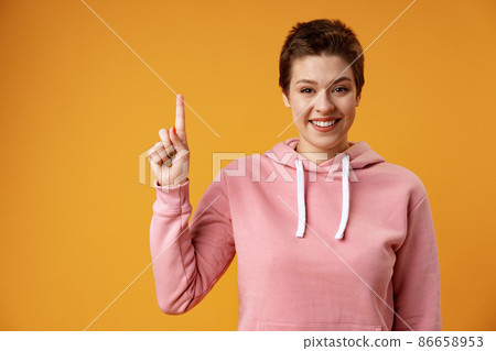 Young woman over isolated yellow background thinking an idea and pointing up 86658953