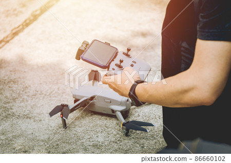 people learning to use smart drone for aerial photography 86660102