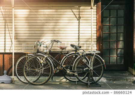 vintage bicycle parking at the street in Japan 86660124