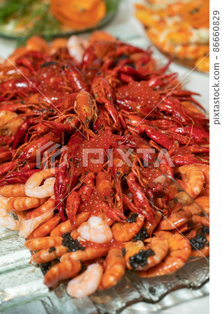 boiled crayfish lie on a platter in a restaurant 86660829