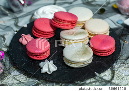 Macaroons. Delicious french desserts. Macaroons with raspberries and cream cheese. Macaroons on the table 86661226