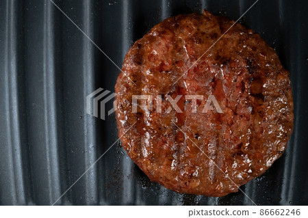 Process of roasting veggie plant-based meat cutlet on barbecue grill plate. Soybean fake patty Process of roasting veggie plant-based meat cutlet on barbecue grill plate. Soybean fake patty 86662246