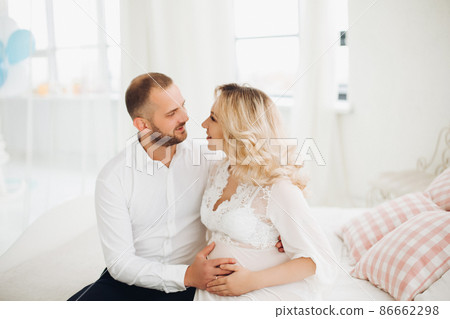 Beautiful couple embracing stomach and touching Beautiful couple embracing stomach and touching 86662298